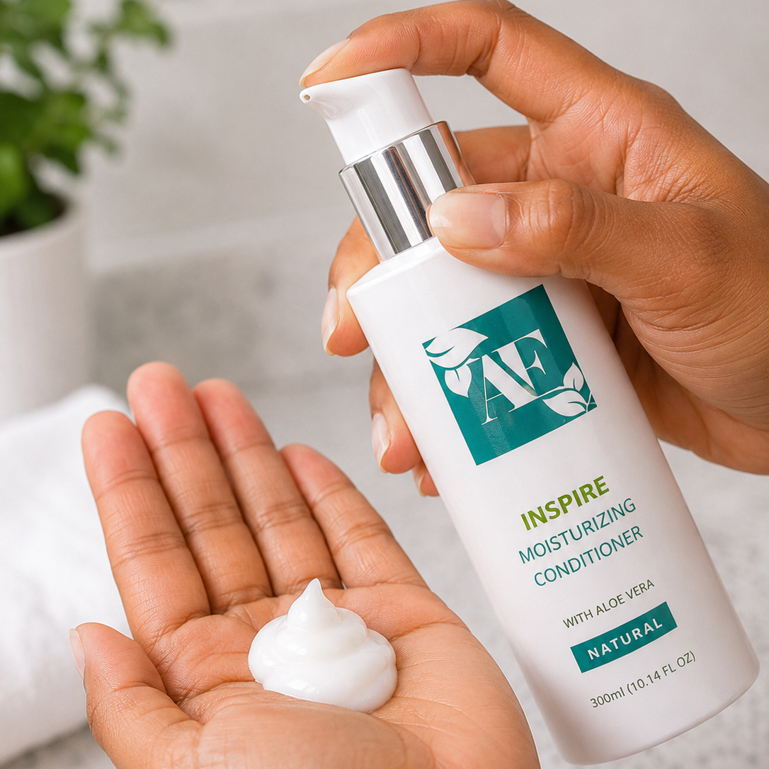 Hand holding a bottle of 'AF' moisturizing conditioner with a small amount on the palm.